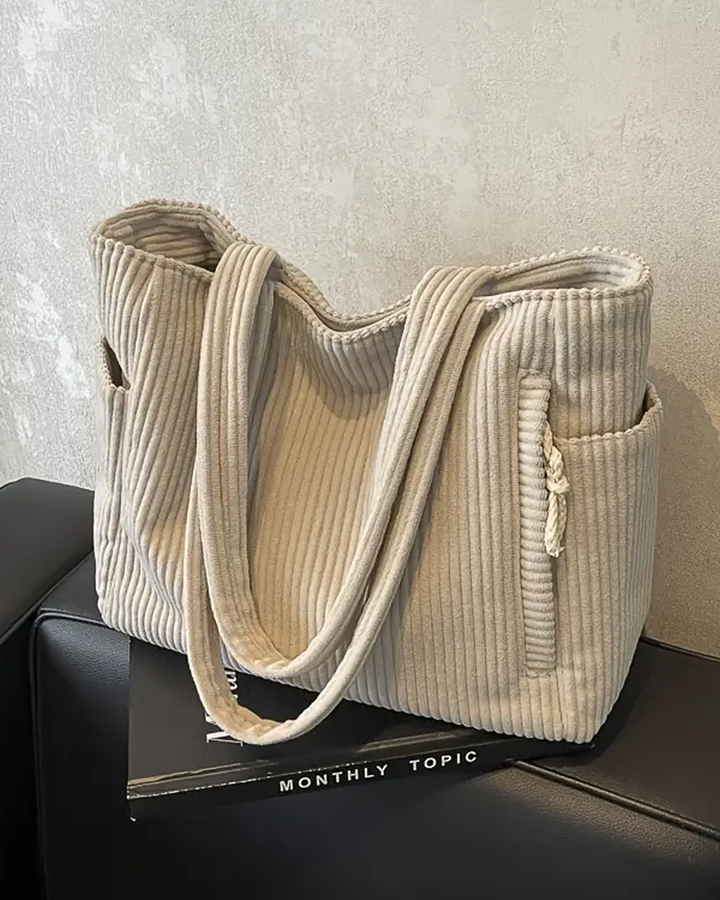 TILDA | BORSA A MANO RIBATTUTA CON DETTAGLI A LACCIO
