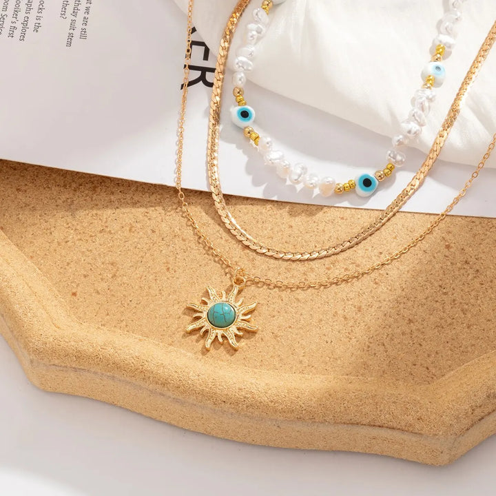 Collane a Strati Parel e Occhio Maligno con Ciondolo Sole Boho