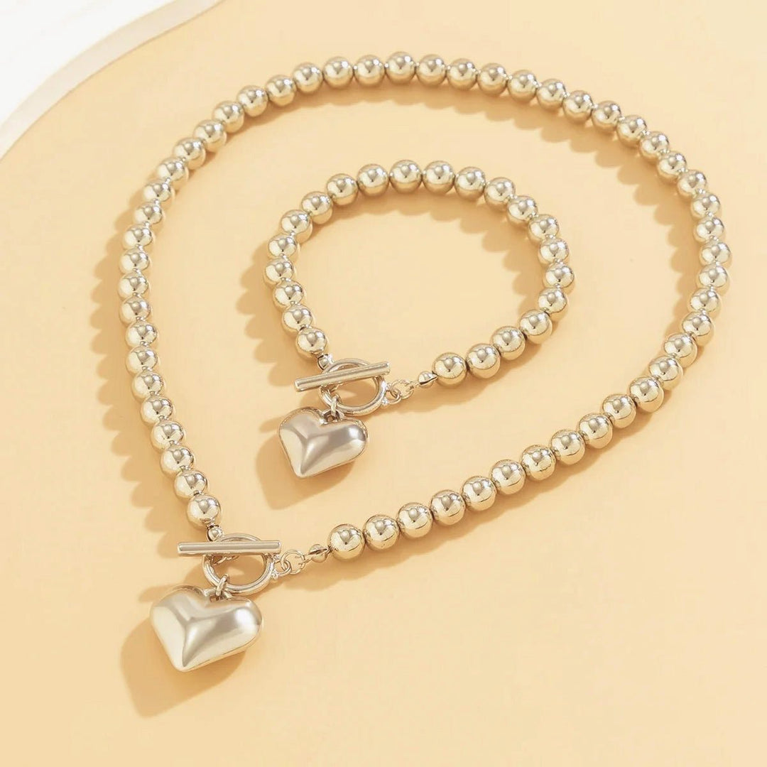 Set di 2 pezzi: bracciale e collana con pendente a cuore in perline