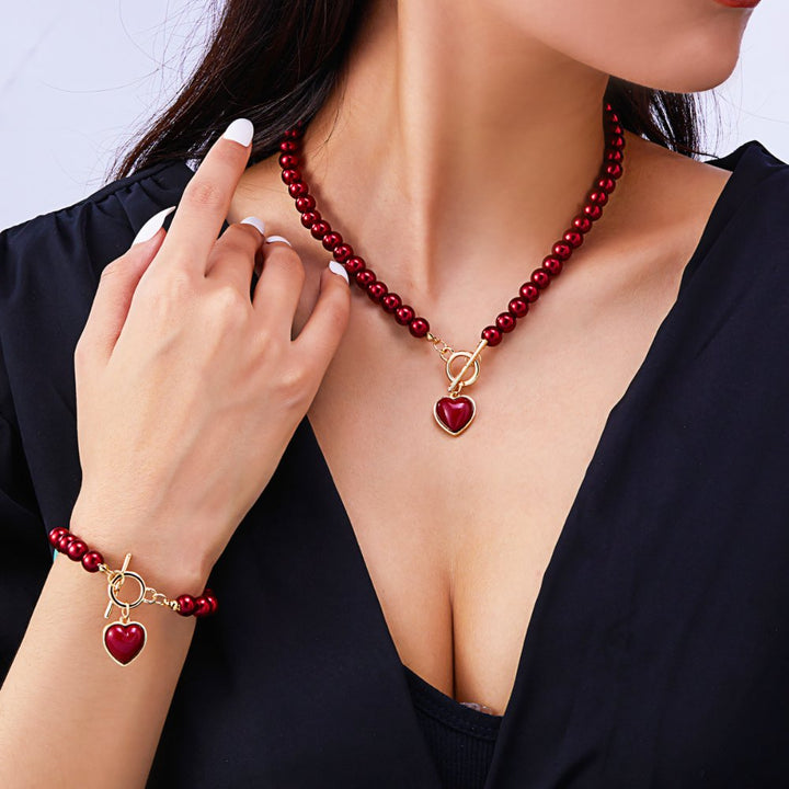 Set di 2 pezzi: bracciale e collana con pendente a cuore in perline