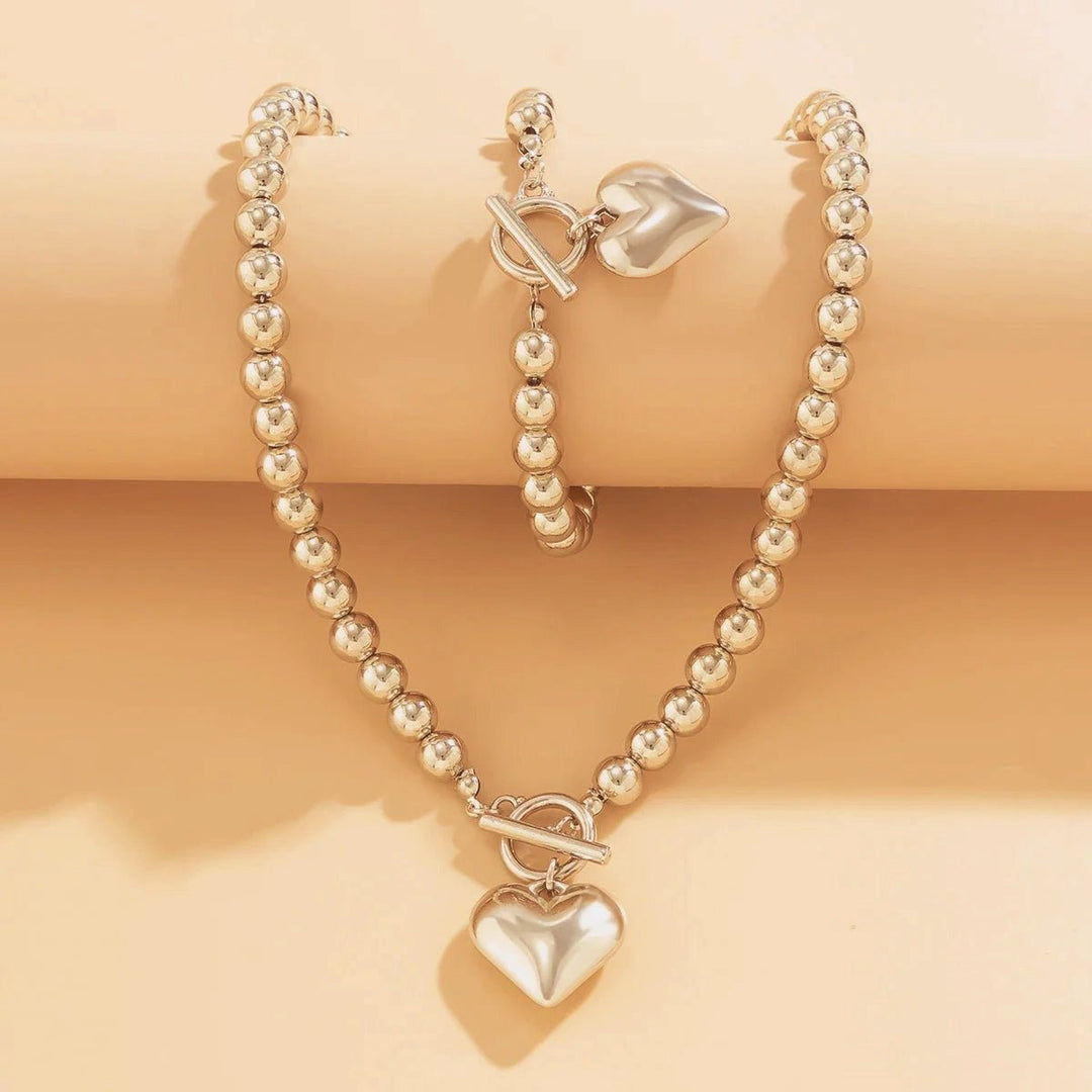 Set di 2 pezzi: bracciale e collana con pendente a cuore in perline