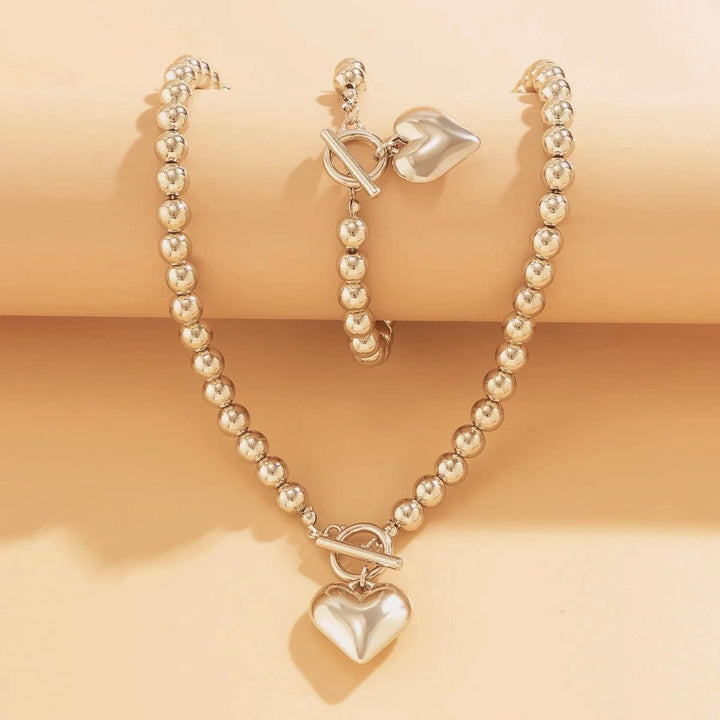 Set di 2 pezzi: bracciale e collana con pendente a cuore in perline
