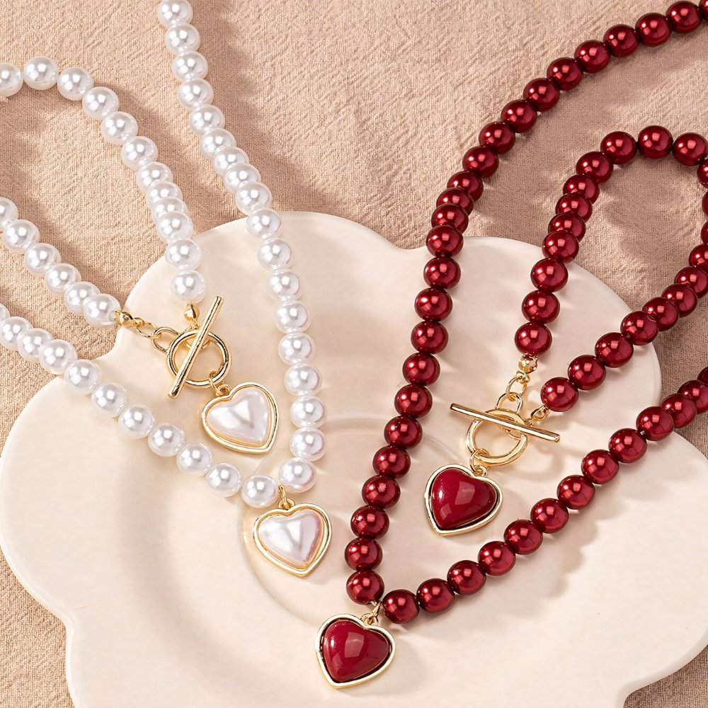 Set di 2 pezzi: bracciale e collana con pendente a cuore in perline